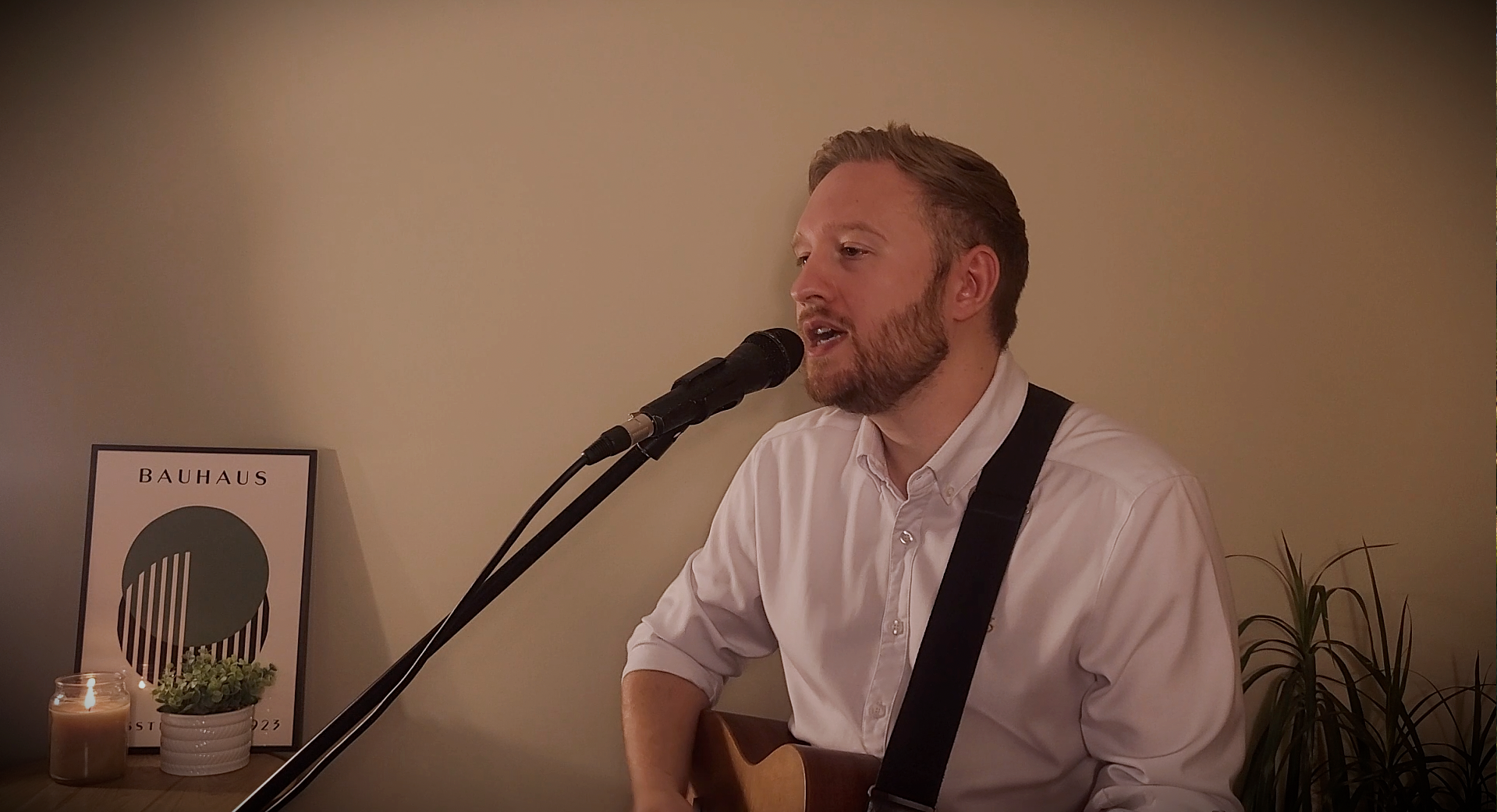 Ben performing live with guitar and microphone
